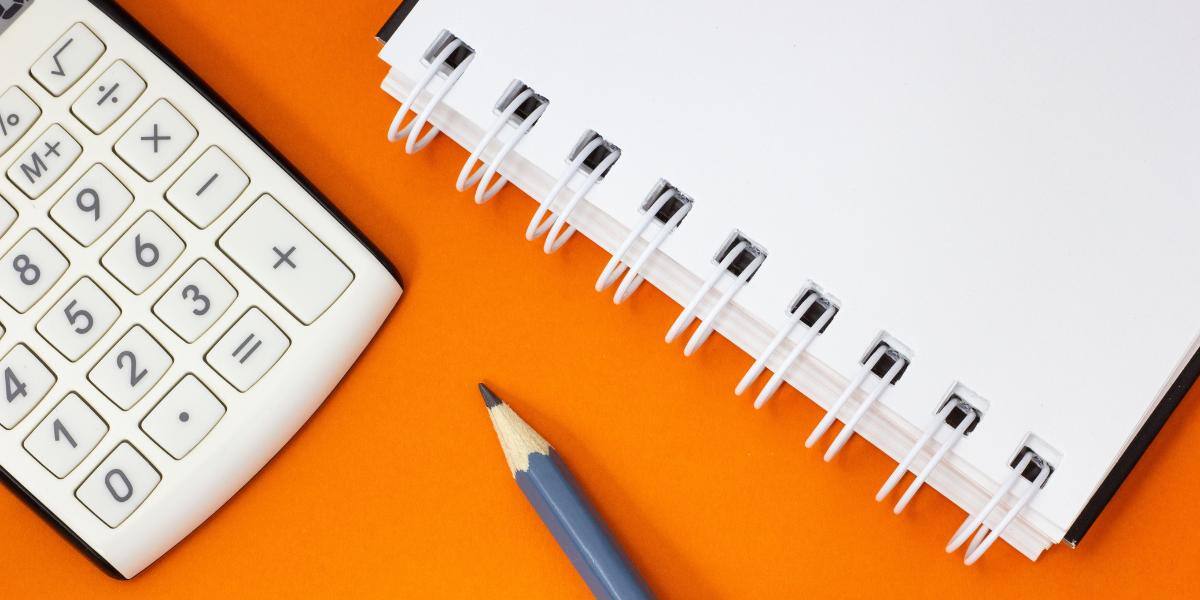 Calculator, notebook and pencil